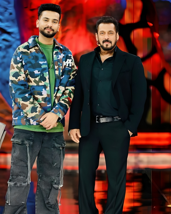 Bigg Boss OTT 2 host Salman Khan standing on stage with winner Elvish Yadav.